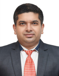 Man in dark suit and red tie